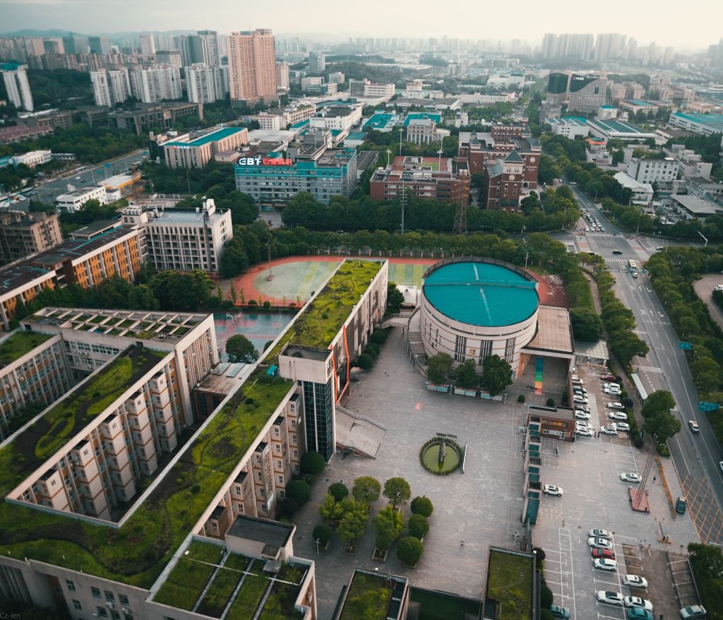 Aerial view of a vibrant urban landscape, showcasing modern architecture and green rooftops.